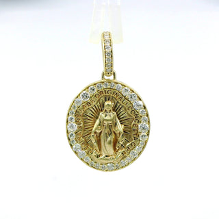 Gold and diamond pendant with religious design on a white background