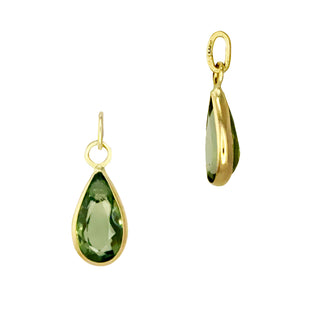 Two gold teardrop earring charms with green sapphire on a white background