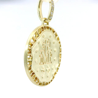 Gold Miraculous medal pendant with engraved design on a white background
