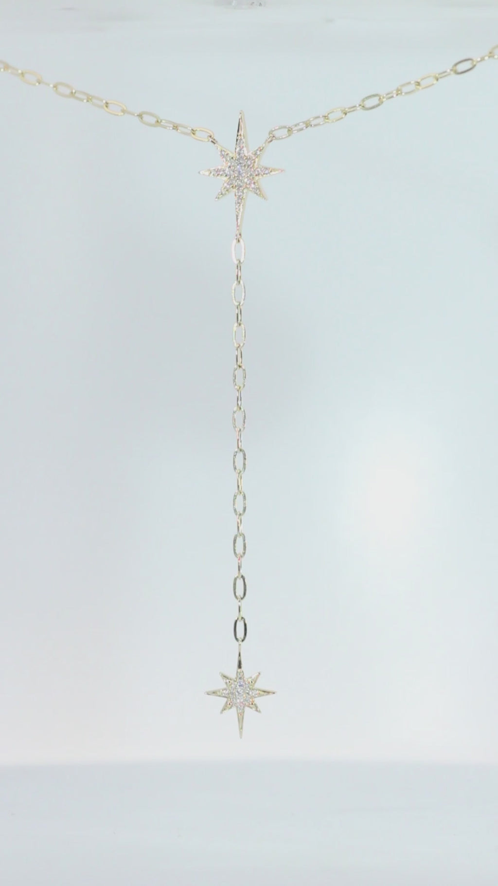 Celestial Moon Drop Necklace by Sorsa Jewellery, a diamond starburst falling to a crescent moon on a 9k gold oval rollo chain.