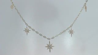 Star Dust Necklace by Sorsa Jewellery, five diamond-set starbursts on a rollo link 9k gold chain.