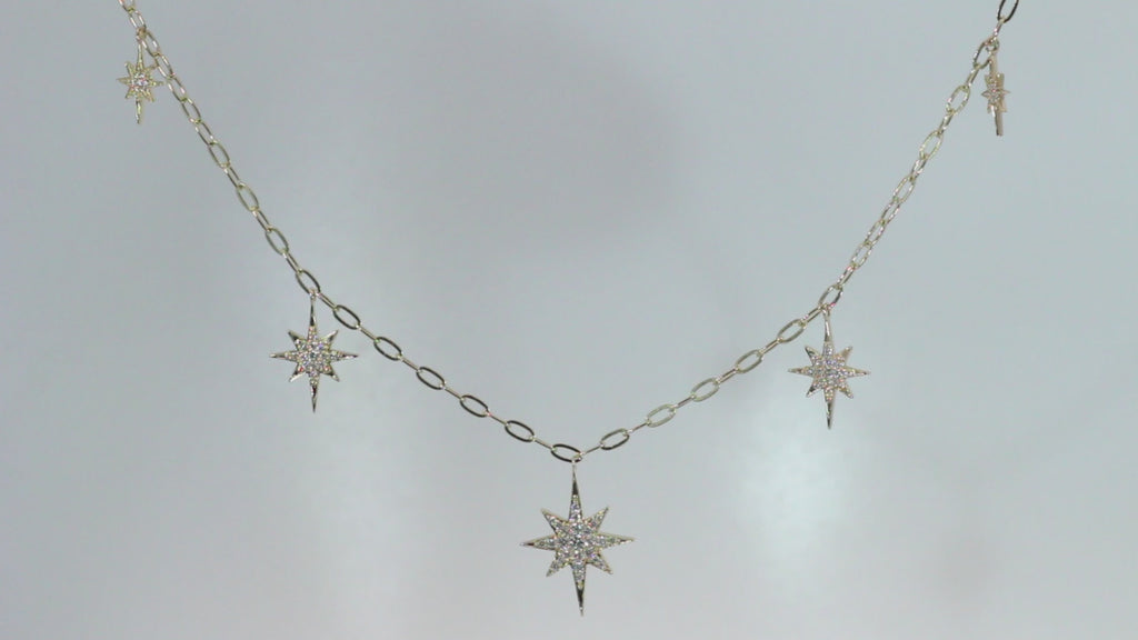 Star Dust Necklace by Sorsa Jewellery, five diamond-set starbursts on a rollo link 9k gold chain.