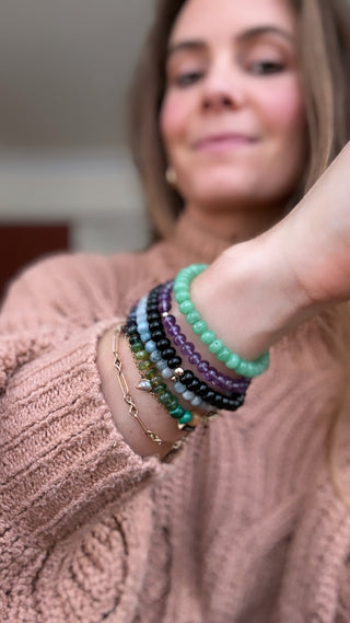 Amethyst stretch bracelet with a 14k gold bead, waterproof everyday design.
