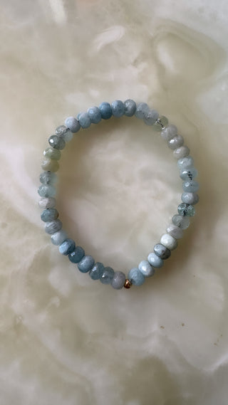 Blue quartz stretch bracelet with faceted stones and a 14k gold bead.