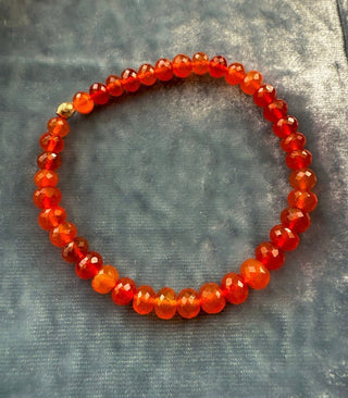 Carnelian stretch bracelet, faceted carnelian beads with a hammered 14k gold bead.