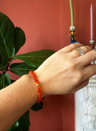 Carnelian stretch bracelet, faceted carnelian beads with a hammered 14k gold bead.