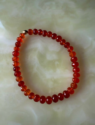 Carnelian stretch bracelet, faceted carnelian beads with a hammered 14k gold bead.