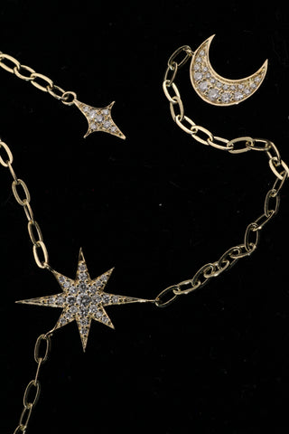 Celestial Moon Drop Necklace by Sorsa Jewellery, a diamond starburst falling to a crescent moon on a 9k gold oval rollo chain.