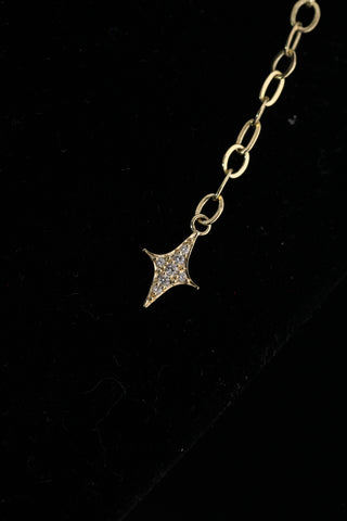 Celestial Moon Drop Necklace by Sorsa Jewellery, a diamond starburst falling to a crescent moon on a 9k gold oval rollo chain.