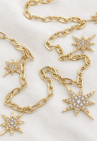 Gold necklace with diamond starbursts, the Celestial Star Dust Necklace by Sorsa Jewellery.
