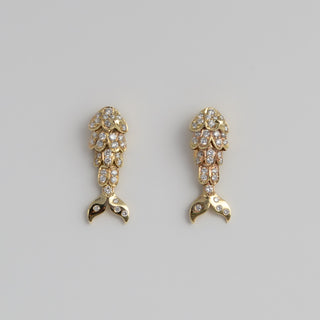Mermaid Tail stud earring in 9k yellow gold with pave diamonds and an articulated tail.