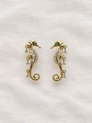 Diamond Seahorse stud earring in 9k gold with an emerald eye and three diamond drops, by Sorsa Jewellery.