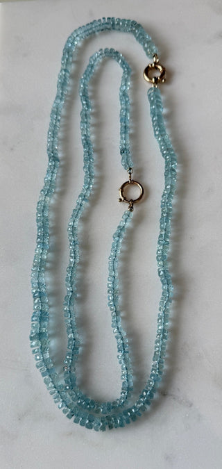 Faceted Aquamarine necklace, hand-knotted aquamarine beads on silk with a 14k gold bolt clasp.