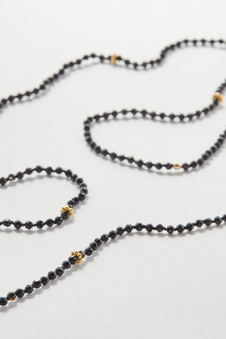 Faceted Black Spinel Pullover Necklace, hand-knotted on black silk with gold daisy beads, no clasp.