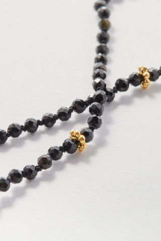 Faceted Black Spinel Pullover Necklace, hand-knotted on black silk with gold daisy beads, no clasp.