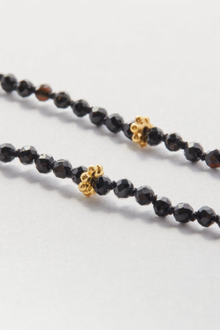 Faceted Black Spinel Pullover Necklace, hand-knotted on black silk with gold daisy beads, no clasp.