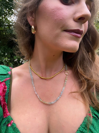 Faceted aquamarine necklace knotted on light blue silk with a 14k gold bolt clasp.