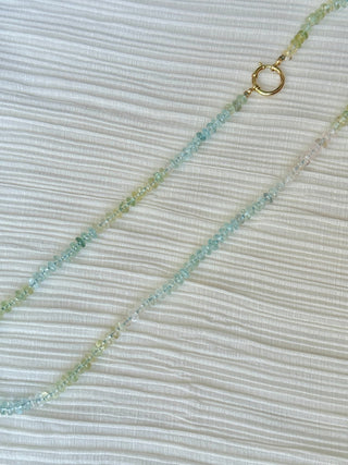 Faceted aquamarine necklace knotted on light blue silk with a 14k gold bolt clasp.
