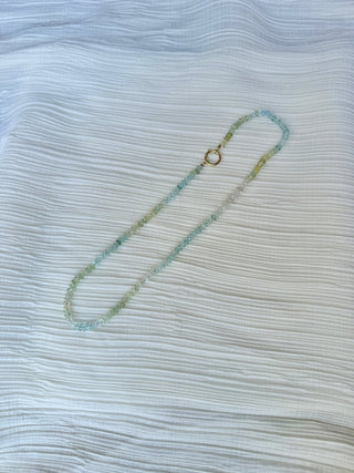Faceted aquamarine necklace knotted on light blue silk with a 14k gold bolt clasp.