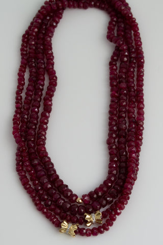 Faceted ruby wrap necklace on silk with 14k gold pave diamond bow details, no clasp.