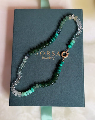 Green Rainbow gemstone necklace worn, tonal green beaded necklace with 9k gold clasp by Sorsa Jewellery, in collaboration with Matilda Goad