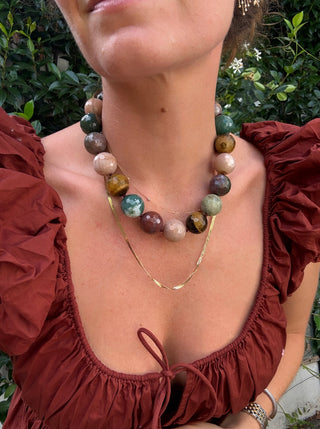Harvest Moon Gemstone Collar by Sorsa Jewellery, styled with a layered gold herringbone chain.