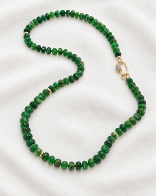 Side view of the Loch Maree Emerald Necklace, emerald beads with a 14k gold pavé diamond carabiner clasp.