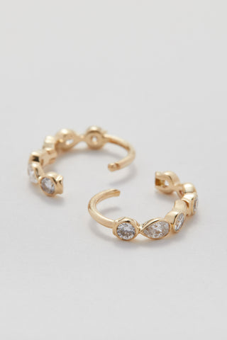 Mini pear and round diamond huggie hoops in 9ct recycled gold, 7mm inner diameter.