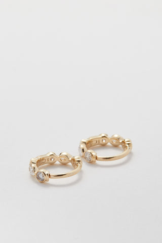 Mini pear and round diamond huggie hoops in 9ct recycled gold, 7mm inner diameter.