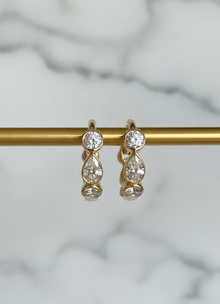 Mini pear and round diamond huggie hoops in 9ct recycled gold, 7mm inner diameter.