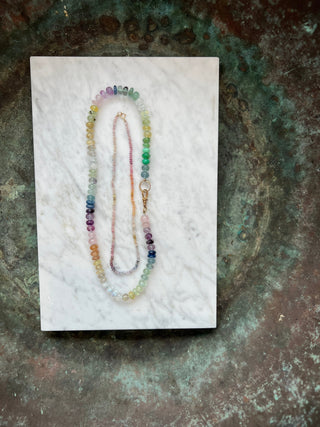 Mini Rainbow Sapphire Choker, rainbow sapphires knotted on silk with a 14k gold bolt clasp.