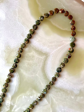 Mossy Autumn Floor bag strap, rhyolite beads knotted on mocha silk with a brass trigger clip.