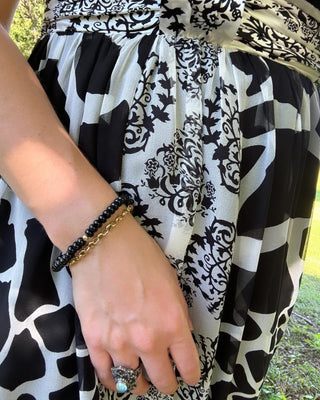 Onyx stretch bracelet with black onyx beads and a 14k gold bead.