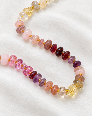 Higgledy-Piggledy gemstone necklace by Sorsa Jewellery, mixed-cut pink, yellow, turquoise and green gemstones hand-knotted on silk with a dainty 9k gold clasp.