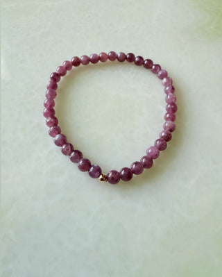 Ruby stretch bracelet, ruby gemstone beads finished with a 14k gold bead.