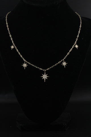 Star Dust Necklace by Sorsa Jewellery, five diamond-set starbursts on a rollo link 9k gold chain.