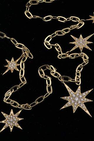 Star Dust Necklace by Sorsa Jewellery, five diamond-set starbursts on a rollo link 9k gold chain.