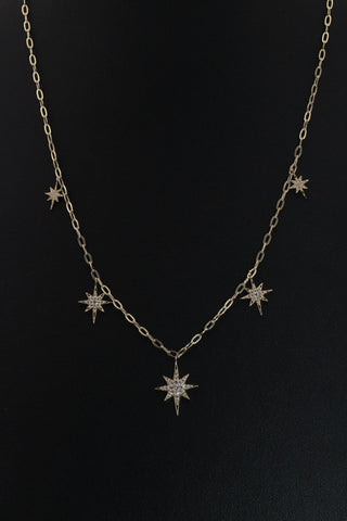 Star Dust Necklace by Sorsa Jewellery, five diamond-set starbursts on a rollo link 9k gold chain.