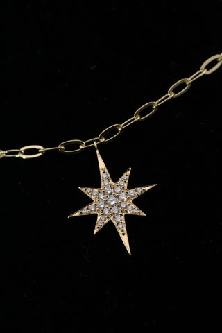 Star Dust Necklace by Sorsa Jewellery, five diamond-set starbursts on a rollo link 9k gold chain.