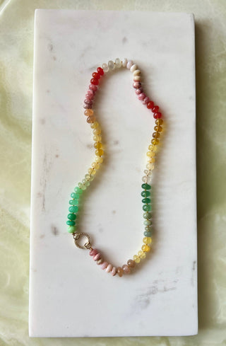 Summer Sunsets necklace, mixed gemstones knotted on silk with a 14k gold diamond charm holder clasp.