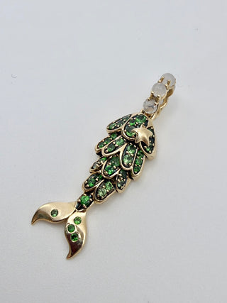 Tsavorite Mermaid Tail Charm by Sorsa Jewellery, green tsavorite scales set in blackened 9k gold with a moonstone bail.