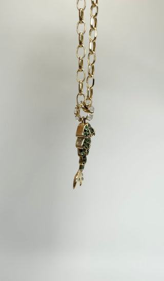 Tsavorite Mermaid Tail Charm by Sorsa Jewellery, green tsavorite scales set in blackened 9k gold with a moonstone bail.