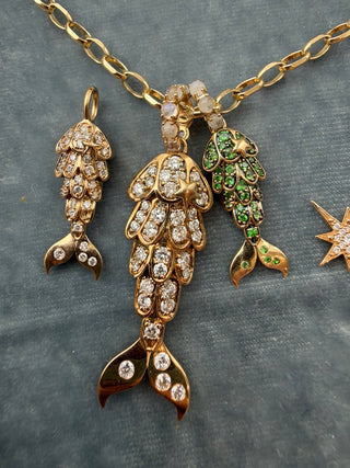 Tsavorite Mermaid Tail Charm by Sorsa Jewellery, green tsavorite scales set in blackened 9k gold with a moonstone bail.