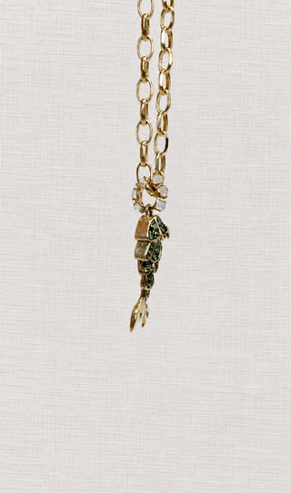 Side view of the Tsavorite Mermaid Tail Charm in blackened 9k gold with moonstone bail, by Sorsa Jewellery.